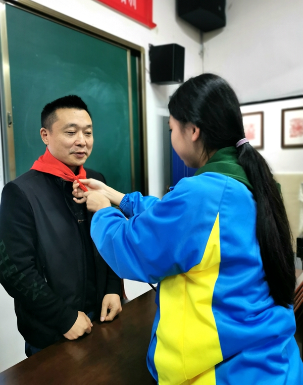少先队员代表为校长柏健佩戴红领巾